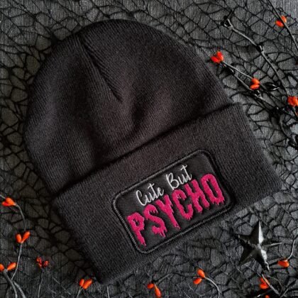 Black Cute But Psycho embroidered gothic beanie on dark background