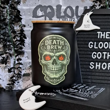 Death Brew gothic glass storage jar with skull design and bamboo lid on black background