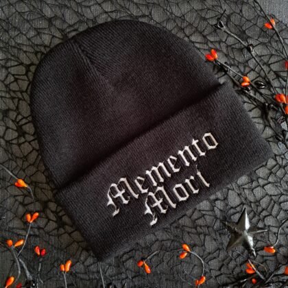 Black Memento Mori gothic embroidered beanie hat on dark textured background