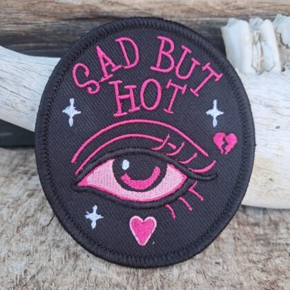 Sad But Hot embroidered patch with pink gothic eye design on black background 10cm iron-on badge