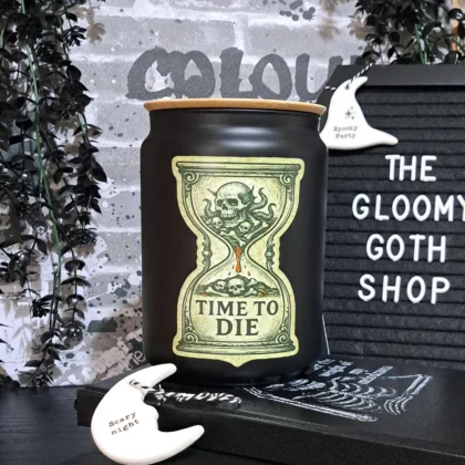 Matte black gothic glass storage jar with bamboo lid featuring skull hourglass Time To Die design