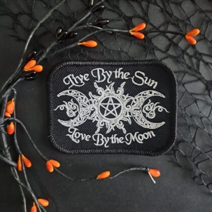 Witchy embroidered patch reading Live By The Sun Love By The Moon with triple moon and pentagram design in white thread on black fabric