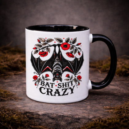 Gothic bat mug with bat shit crazy text and floral bat illustration on stone background