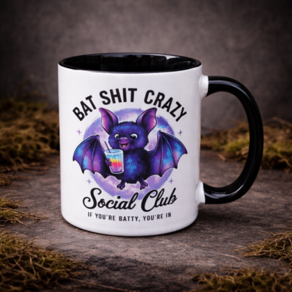 Cute bat mug with bat shit crazy social club text and colourful cartoon bat design