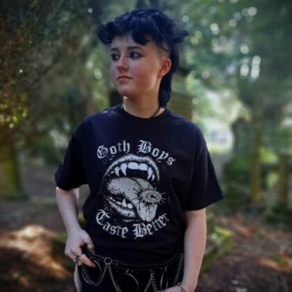 Model wearing Goth Boys Taste Better gothic 0vampire mouth graphic t-shirt printed in white on a black cotton tee. A great alternative Emo t-shirt gift idea.