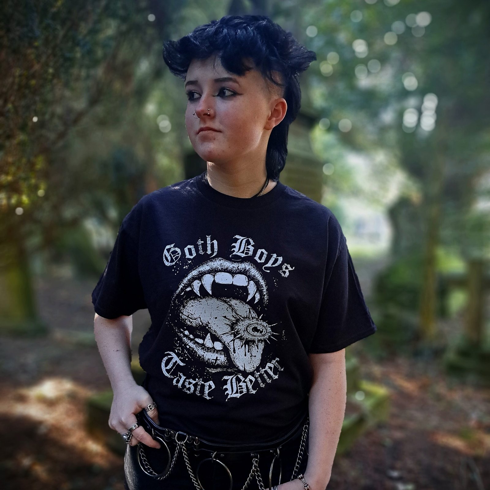 Model wearing Goth Boys Taste Better gothic 0vampire mouth graphic t-shirt printed in white on a black cotton tee. A great alternative Emo t-shirt gift idea.