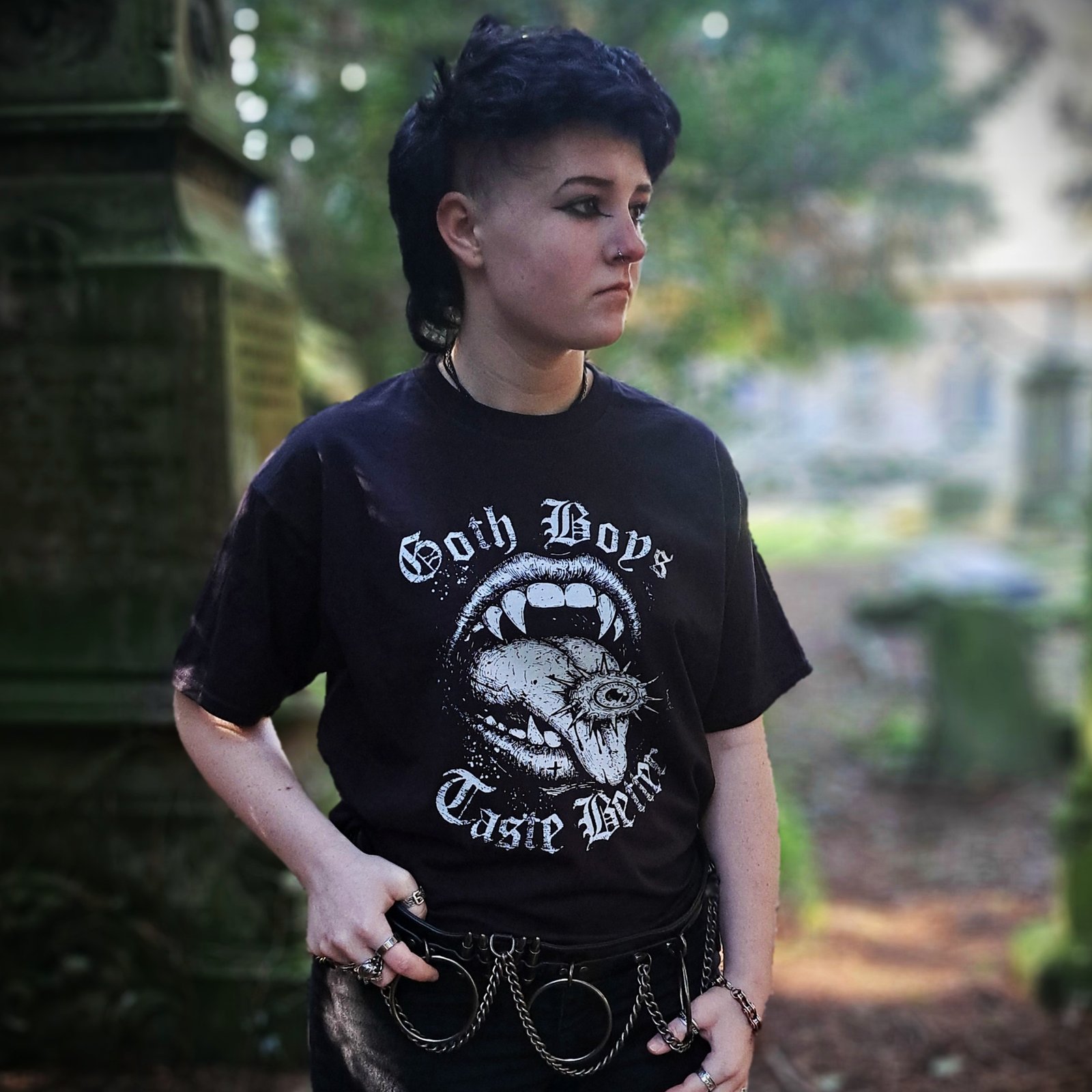 Close up of Goth Boys Taste Better vampire mouth gothic graphic printed on black t-shirt