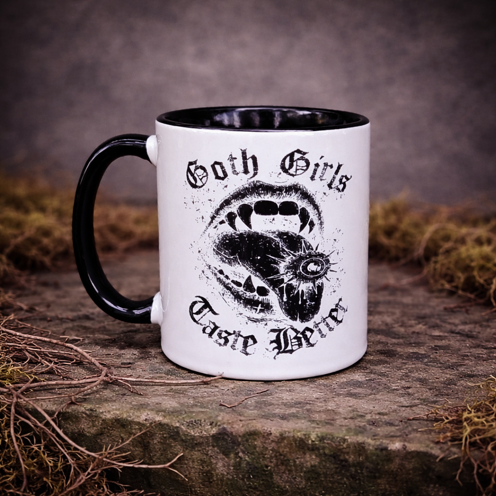 Goth girls taste better mug with gothic lips design and black handle on white ceramic, styled on dark moss background