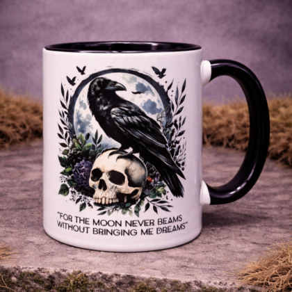 Gothic raven skull mug with moon and quote design, black handle on right, coffee cup on moss stone background
