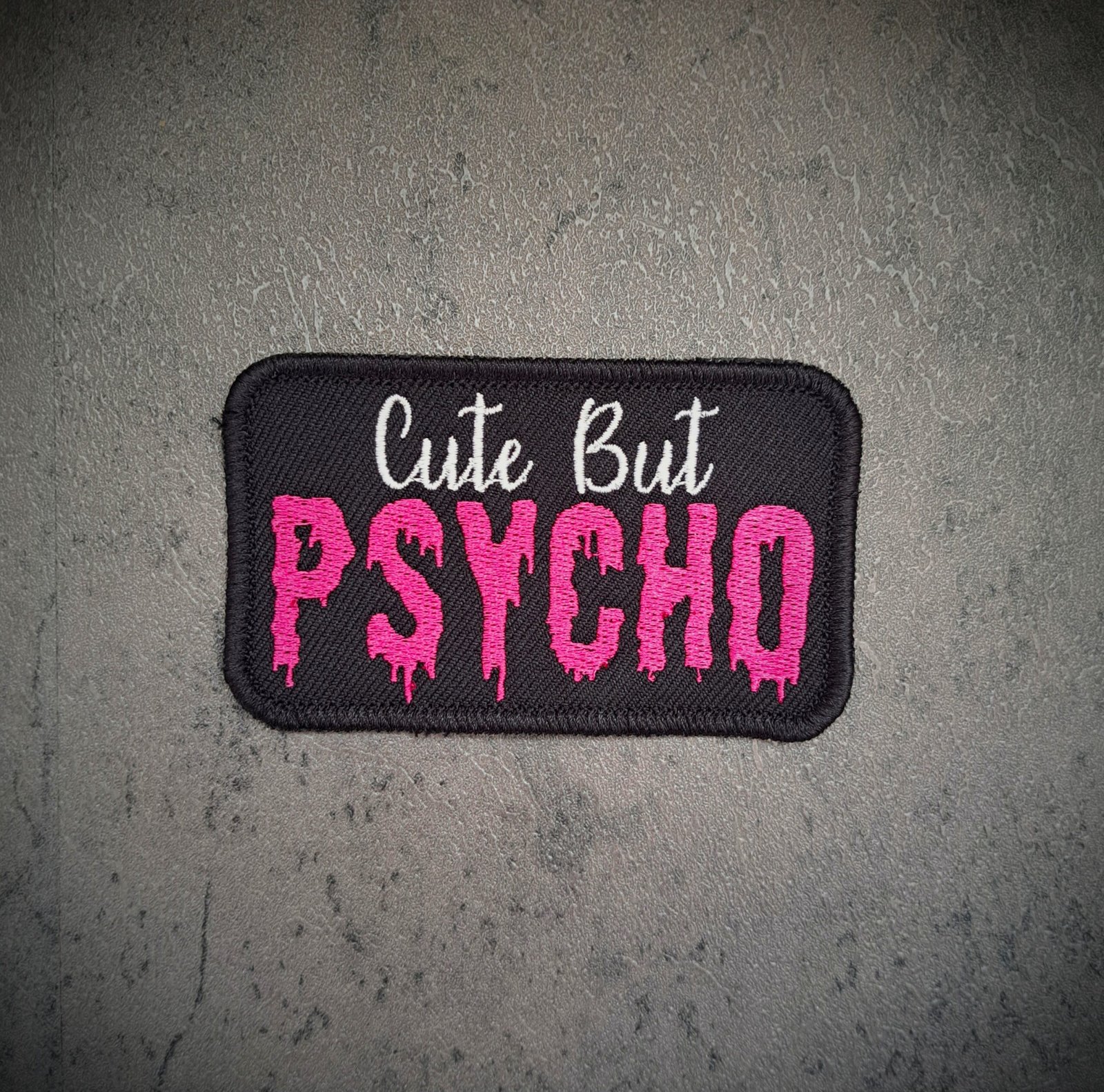 Alternative Cute But Psycho embroidered slogan patch in pink and black