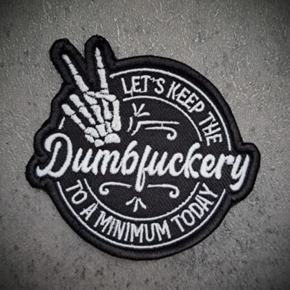 Dumbfuckery embroidered patch with skeleton hand design in black and white